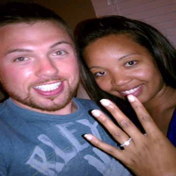Young couple wearing engagement ring